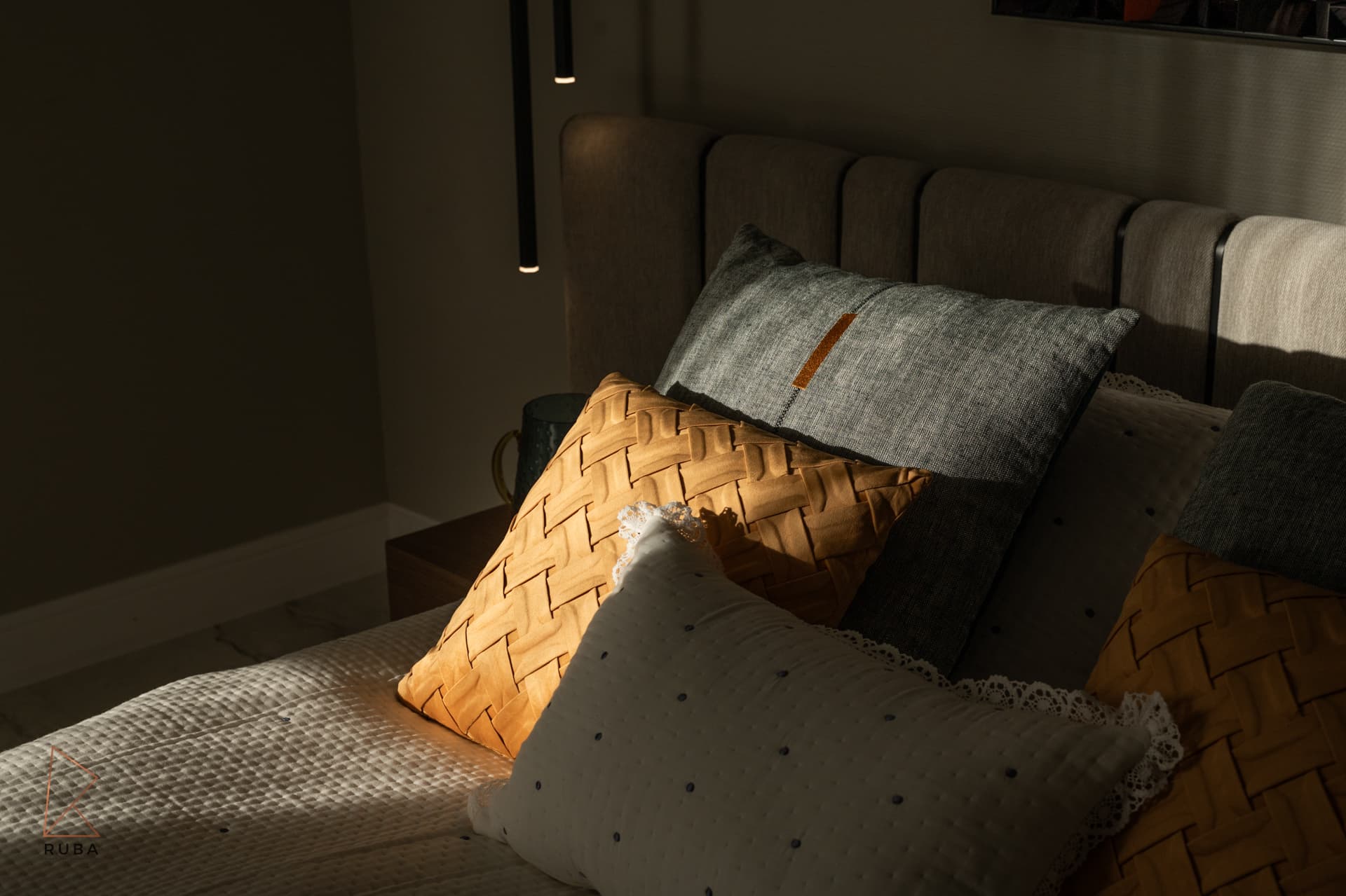 Sunlit ochre basket-weave cushion and grey linen pillow against a channelled headboard in the second bedroom of Bird of Paradise Flower