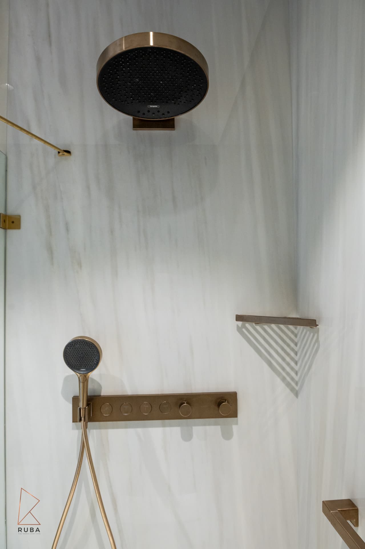 Bronze rain shower head, handheld shower and control bar on pale veined stone in the master bathroom of Bird of Paradise Flower