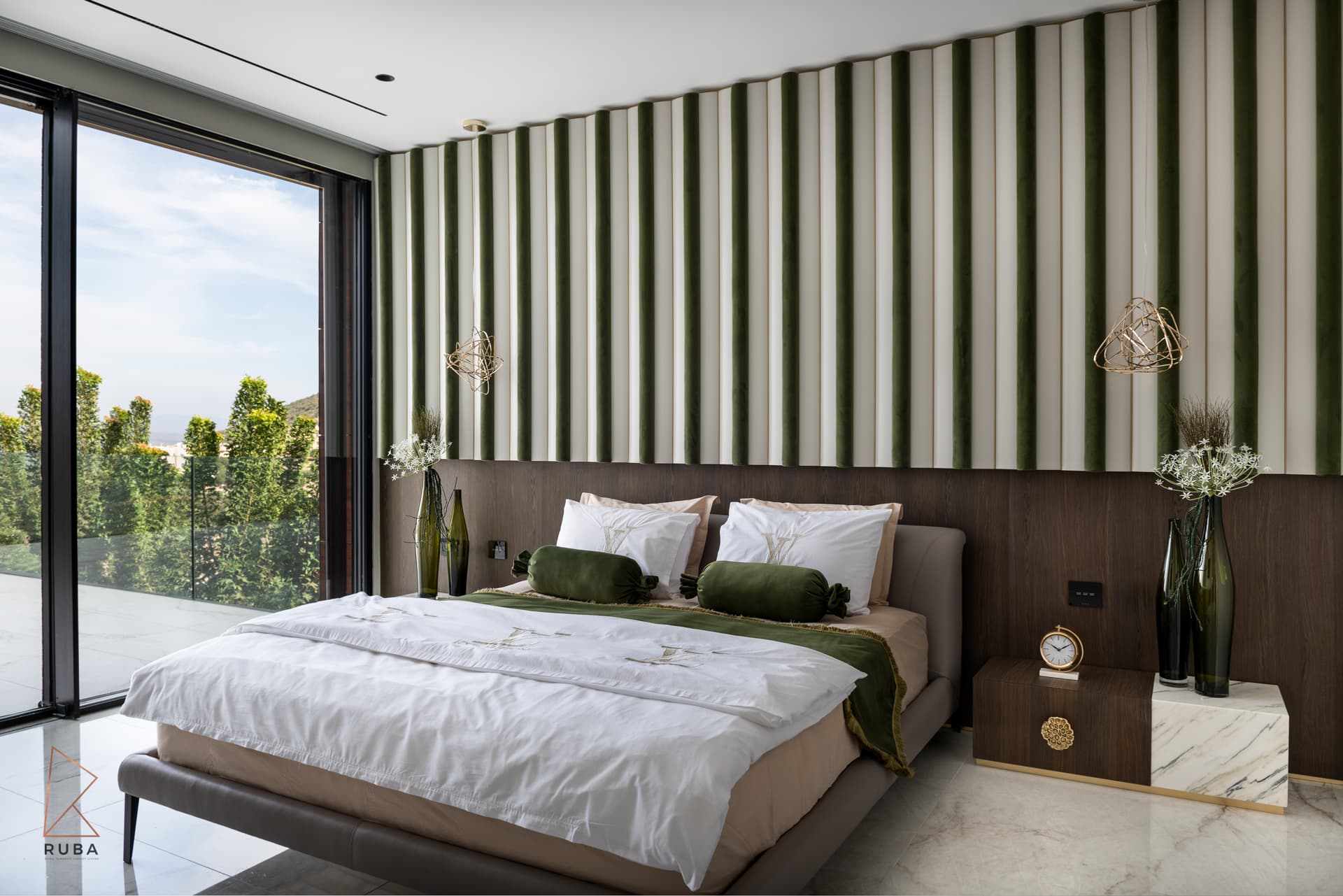 Angled view of the bed, striped velvet wall and gold wire pendants by a full-height window in the master bedroom of Bird of Paradise Flower