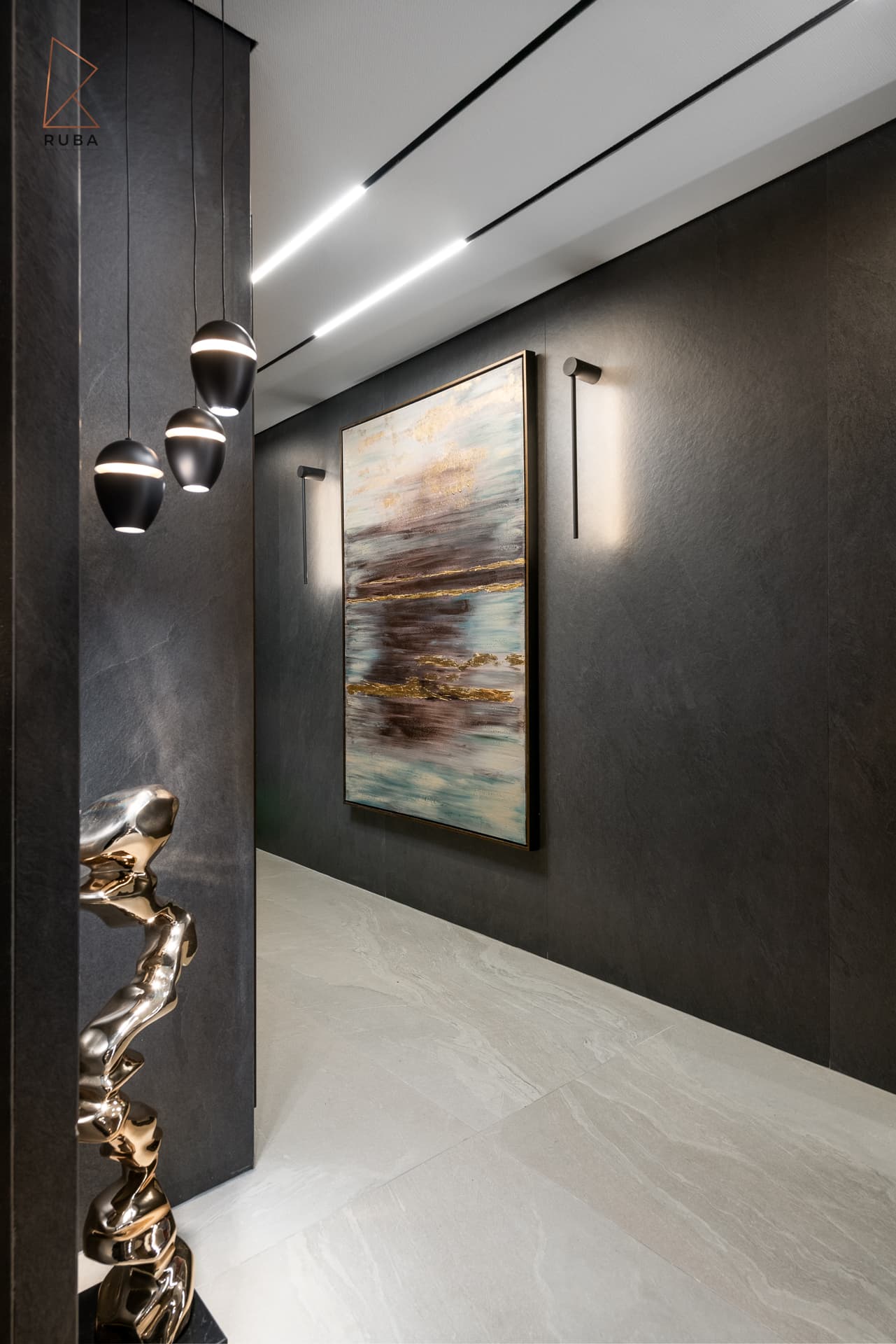 Dark stone hallway with linear ceiling lights, an abstract painting and black globe pendants in the entrance hallway of Khayyal
