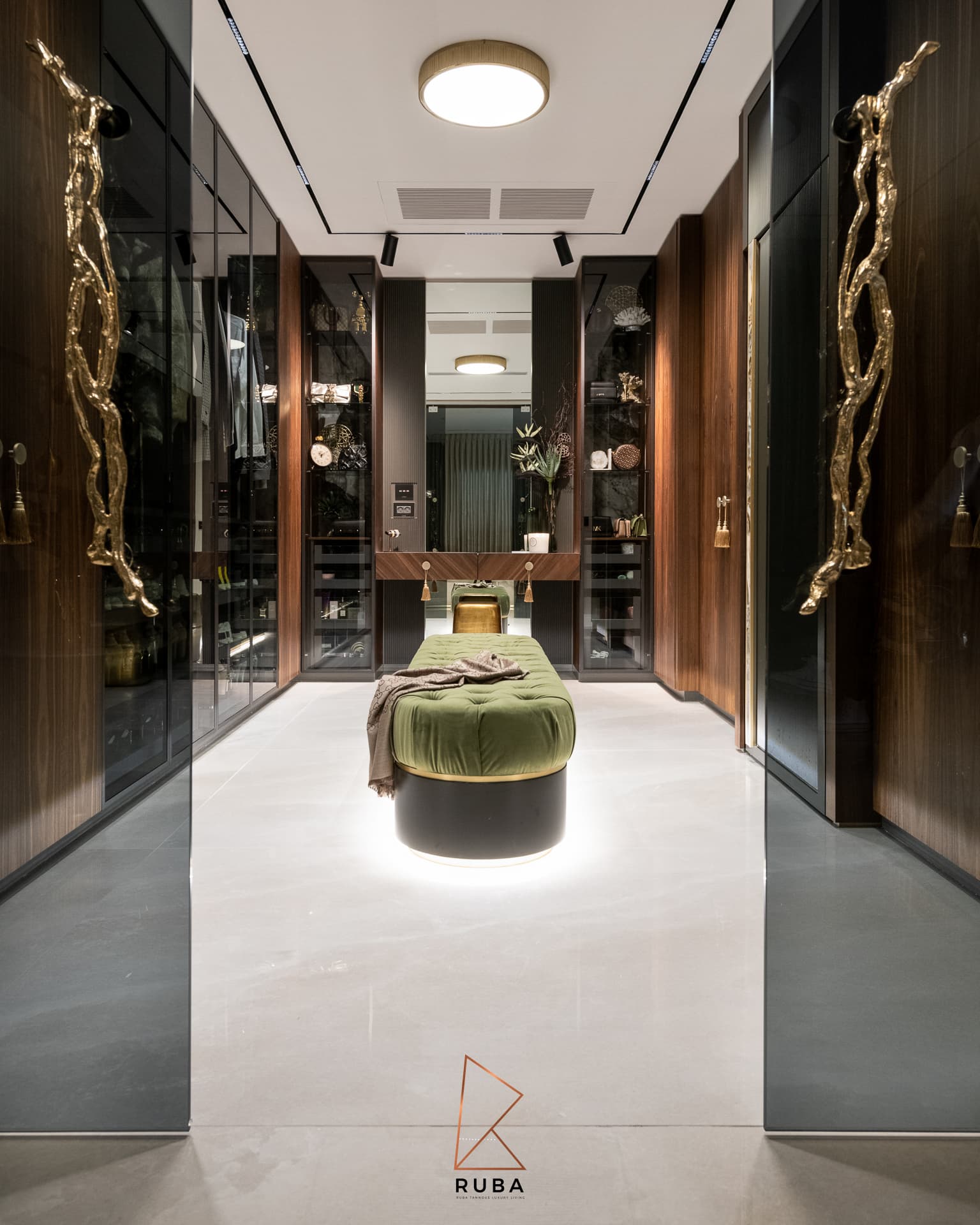 Walk-in dressing room with sculpted brass branch door pulls and a lit green tufted velvet bench in Patagonia