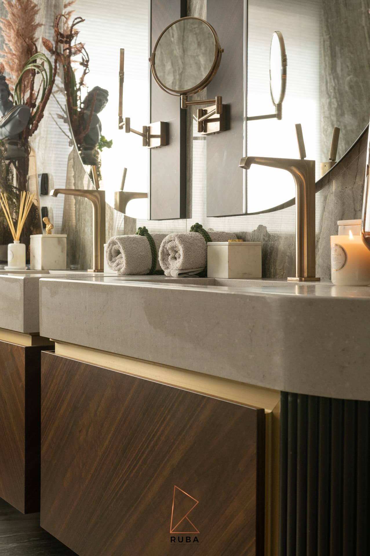 Side view of a floating vanity with diagonal walnut drawers and brass trim in the master bathroom of Patagonia