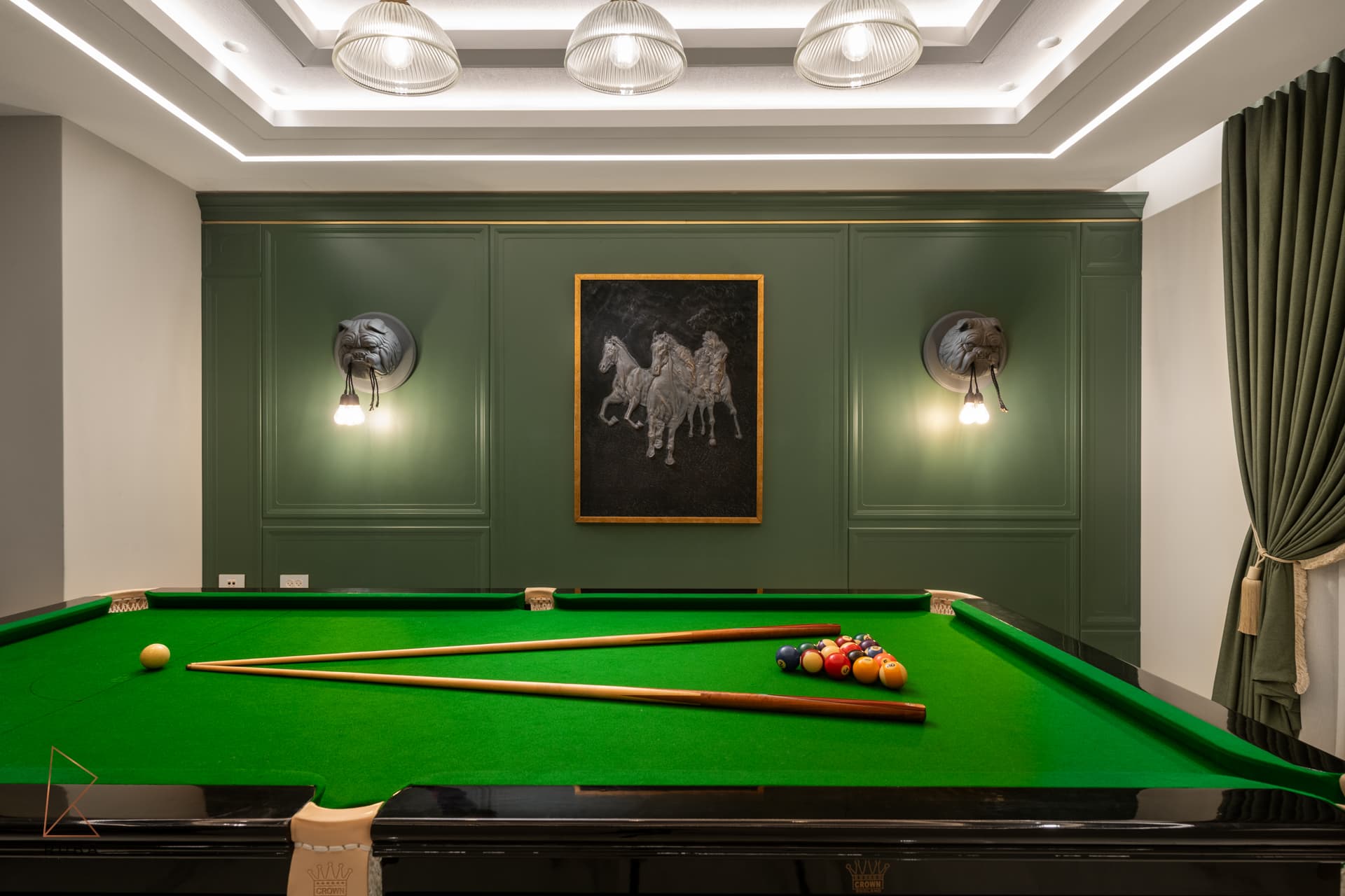 Basement games room with a billiard table, green panelled wall, framed horse artwork and animal-head wall sconces in The Last Supper