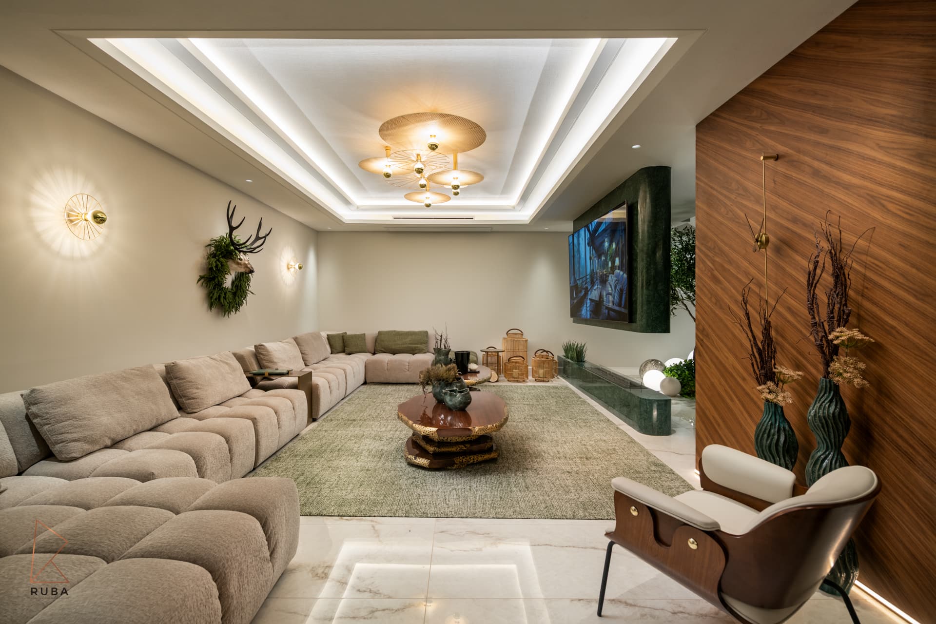 Basement lounge with a long modular sofa, walnut feature wall and layered cove ceiling with brass pendant in The Last Supper