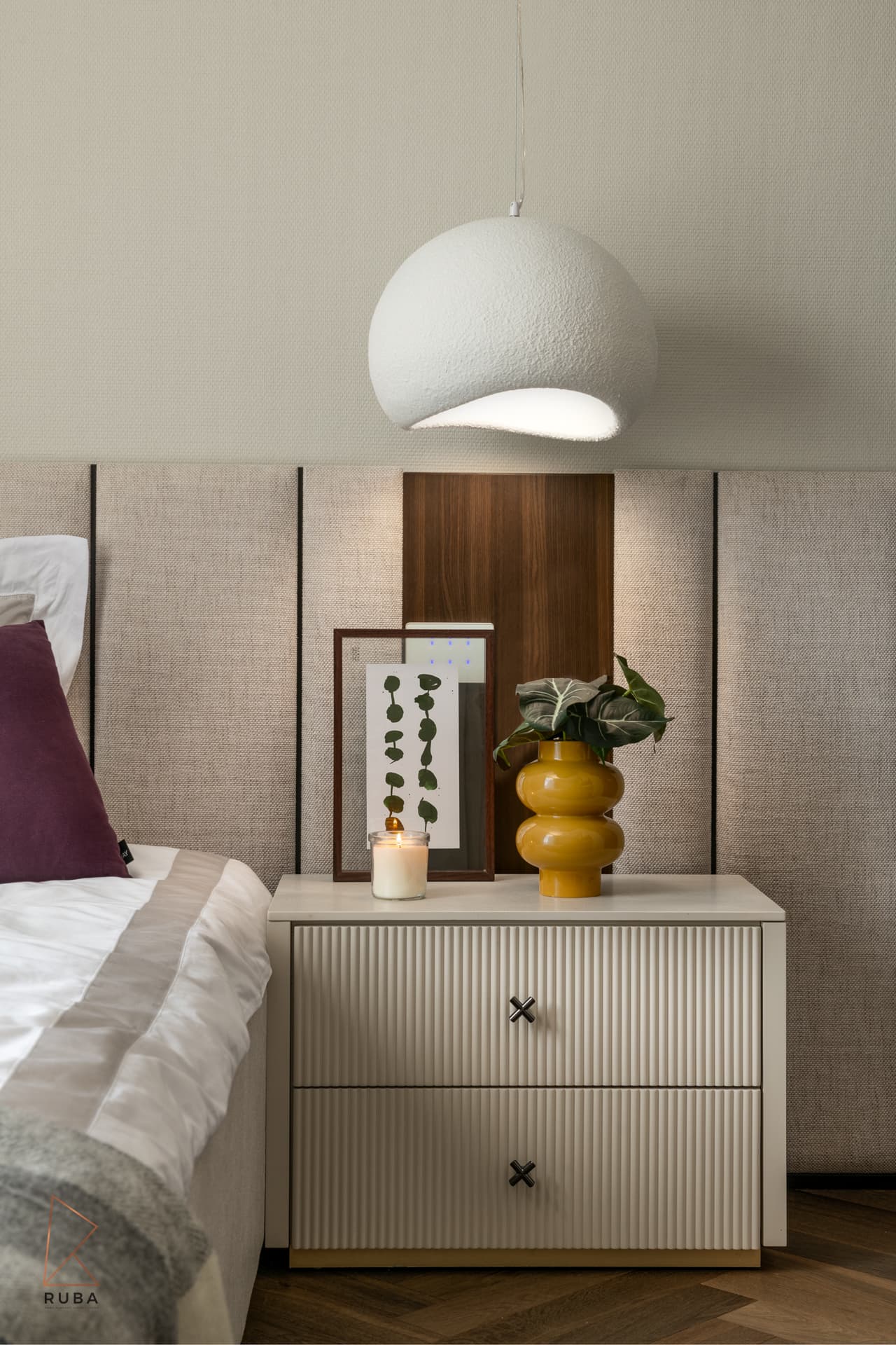 Fluted cream nightstand with cross-shaped knobs beneath a white dome pendant in a kids bedroom of The Last Supper