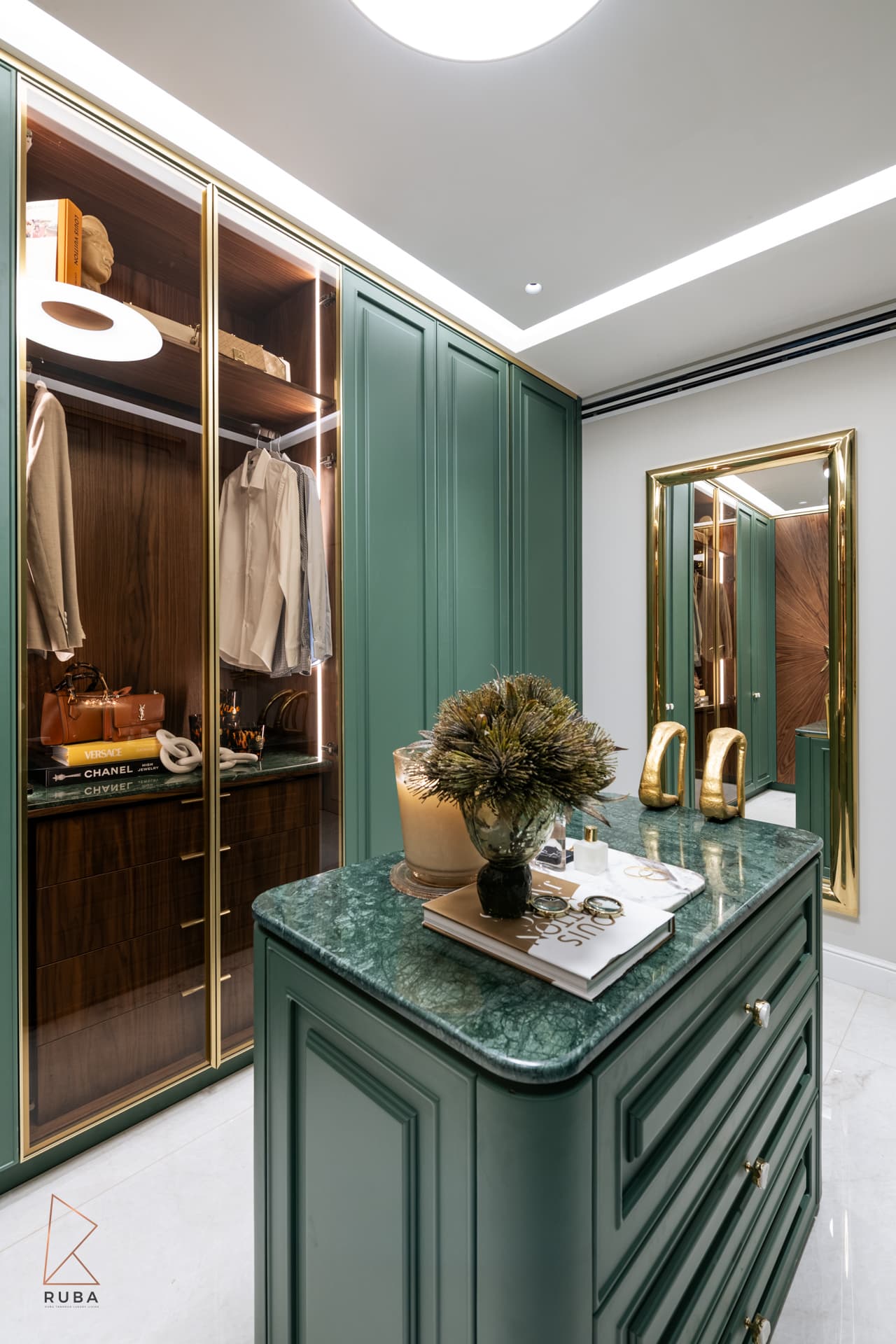 Green dressing room with brass-framed glass wardrobes, marble-topped island and a gold-framed full-length mirror in The Last Supper