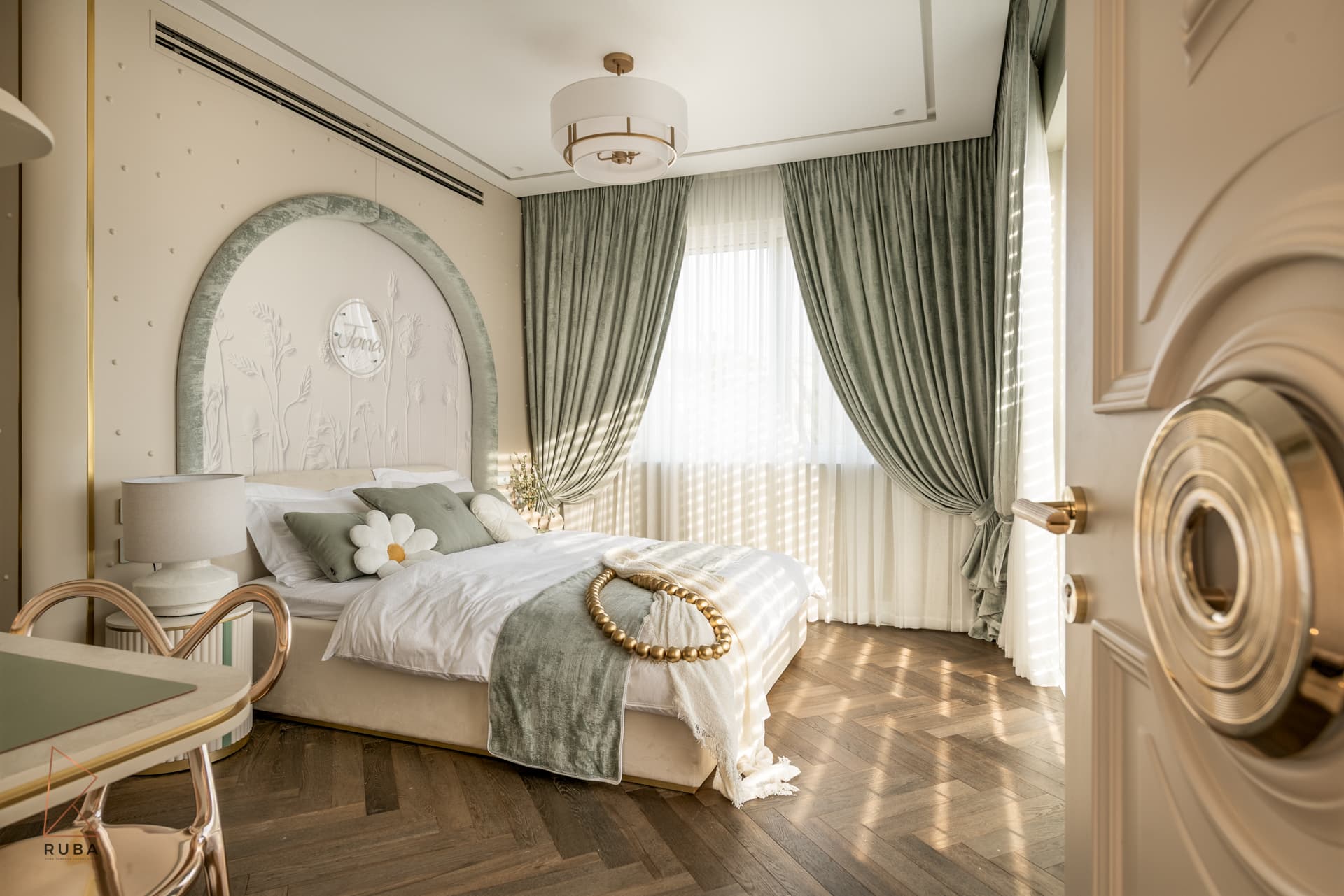 Kids bedroom seen through a sculpted door with an arched sage velvet headboard and floral relief wall in The Last Supper