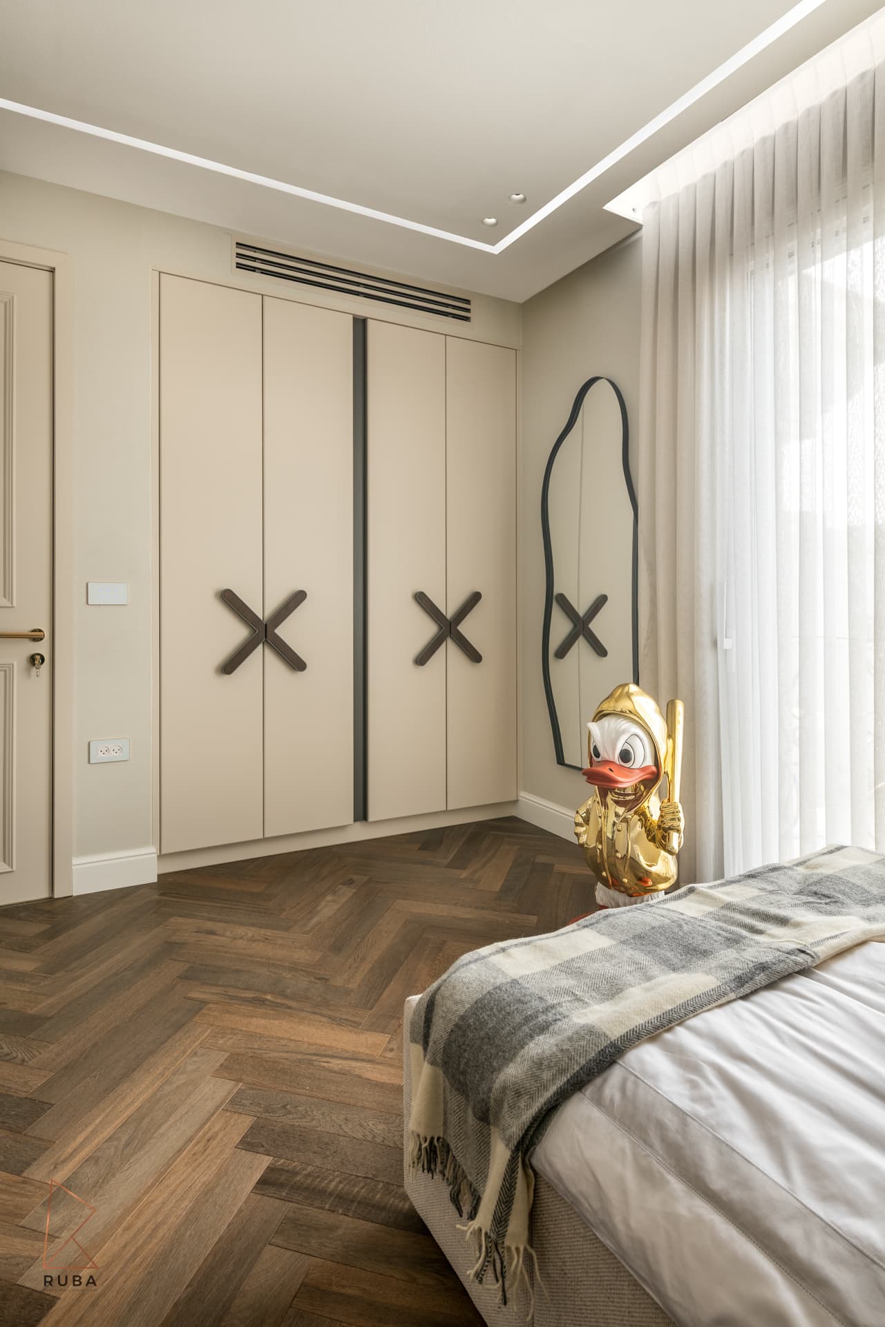 Kids bedroom wardrobe with oversized cross-shaped handles and a curved wall mirror in The Last Supper
