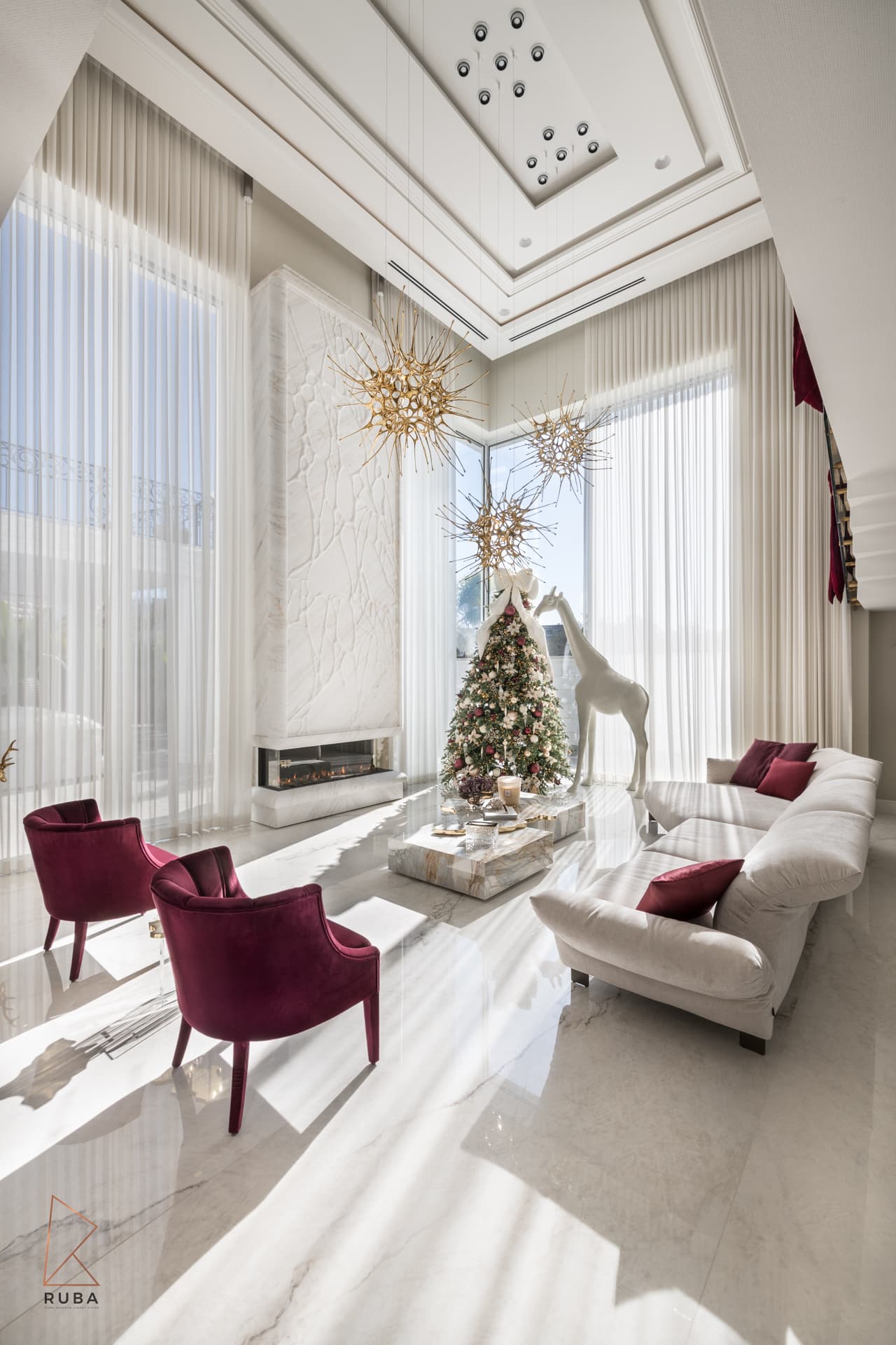 Tall view of the living room showing a coffered ceiling, linear fireplace and gold starburst chandeliers in The Last Supper