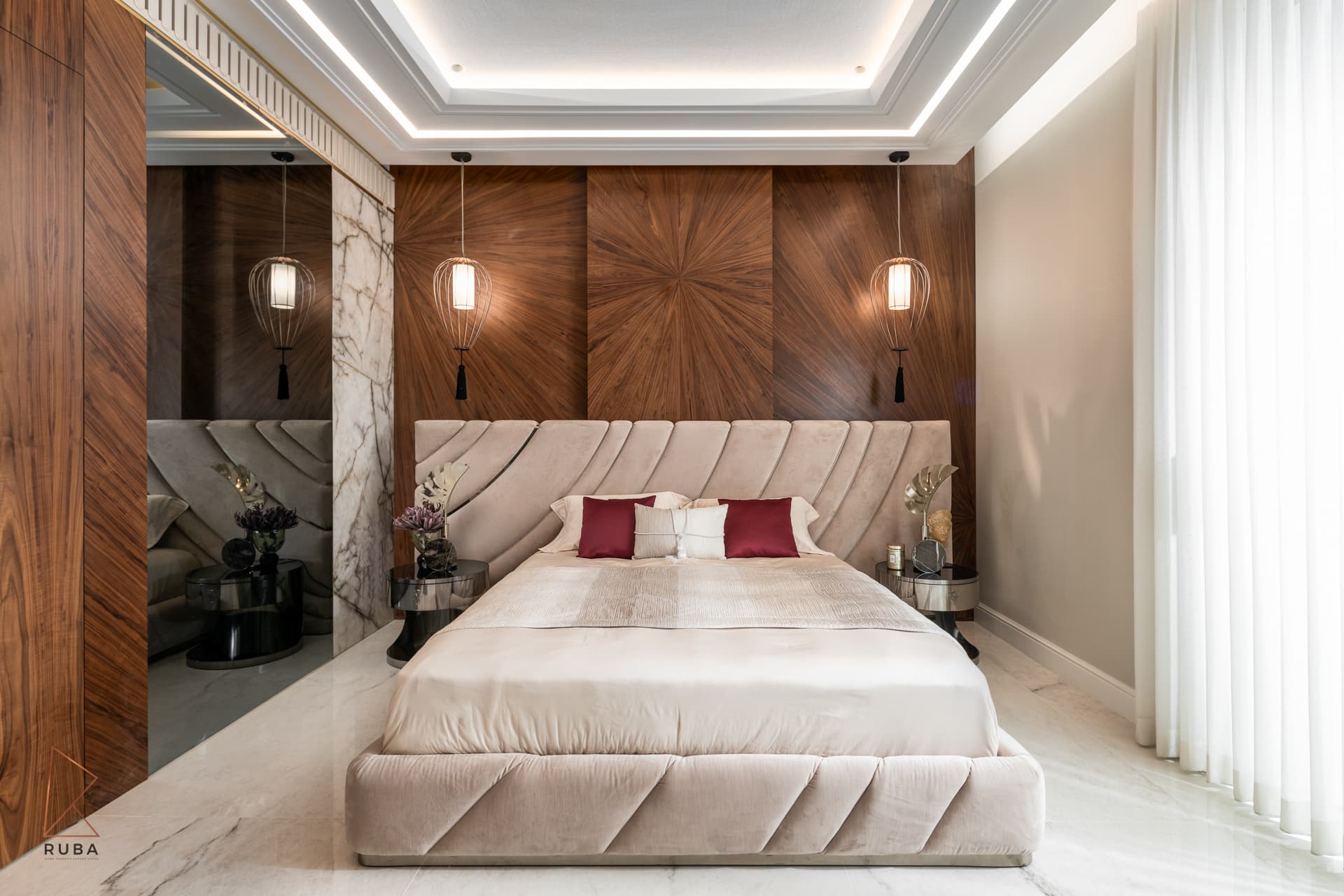 Master bedroom with a channel-quilted headboard against a sunburst walnut wall and caged pendant lights in The Last Supper