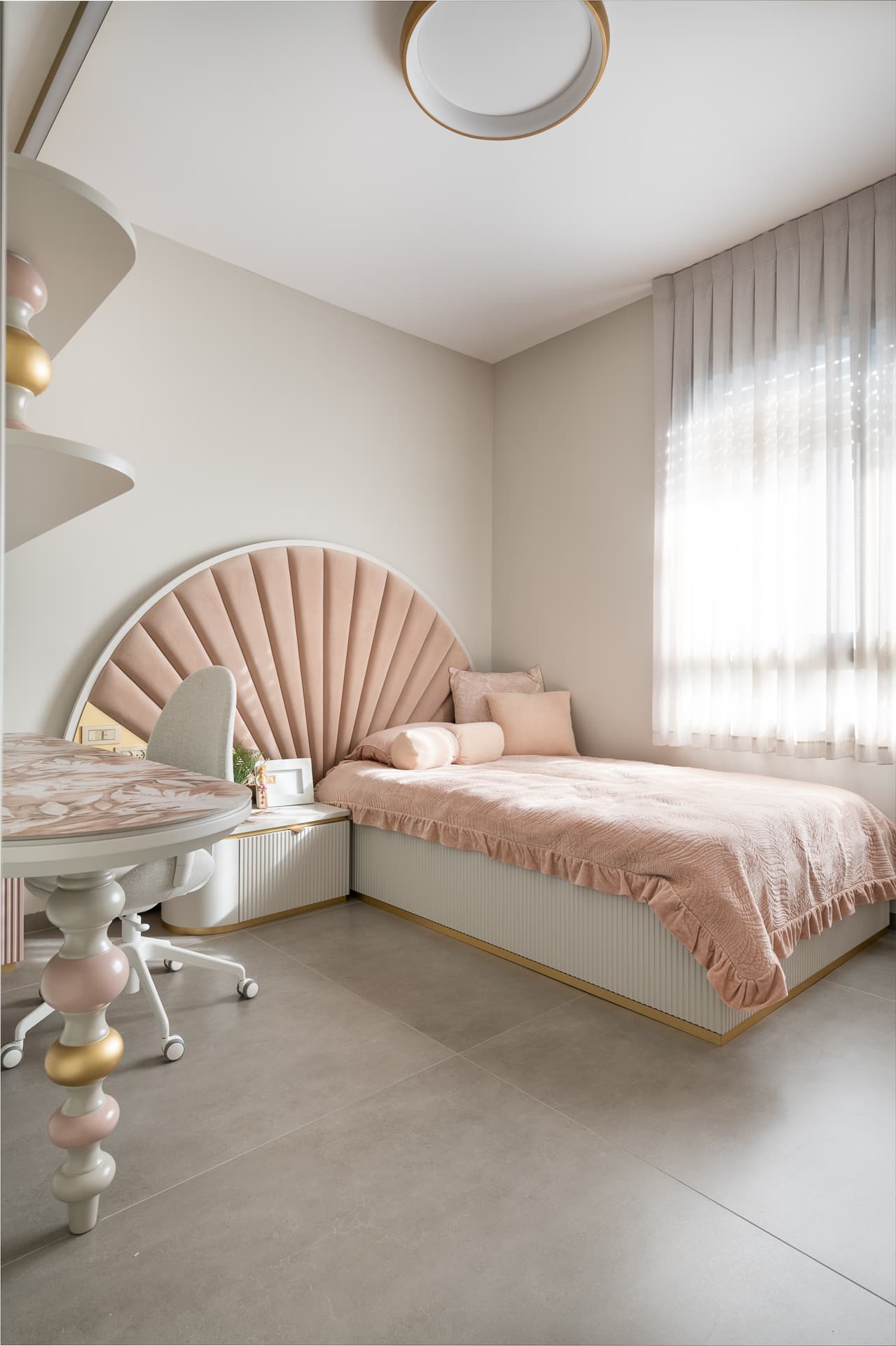 Blush velvet fan headboard and fluted white bed base beside a sheer-curtained window in the girls room of Timeless Union